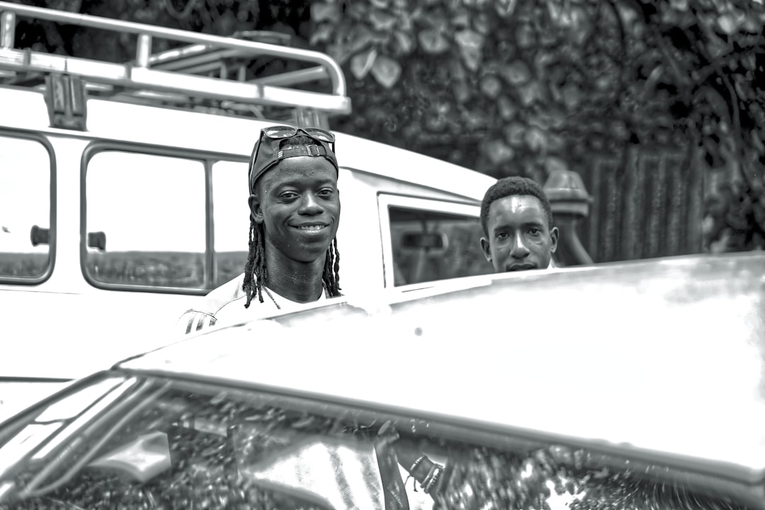 A group of happy people smiling widely for a vintage camera, illustrating the 'say cheese' effect in photography.