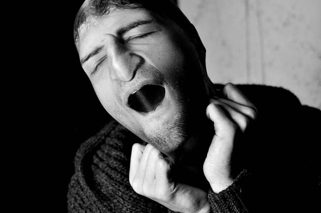 A close-up shot of a person mid-sneeze, representing the common human act that sparks the 'bless you' tradition with its rich historical and cultural roots.