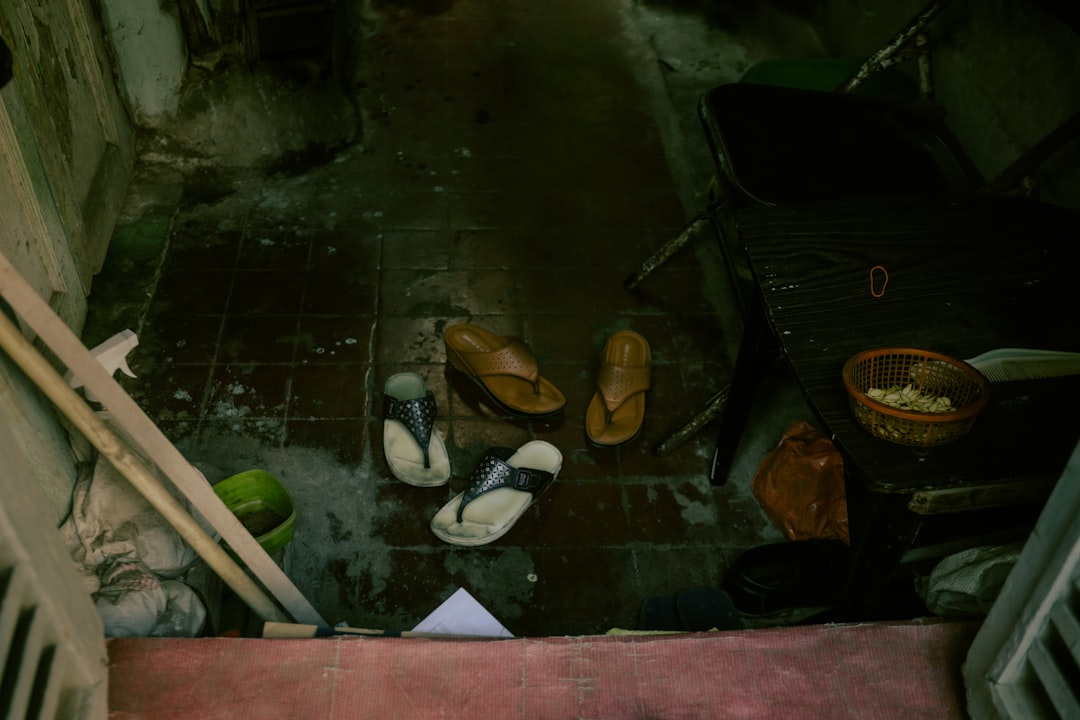 A pair of shoes placed neatly at the threshold of a modern home, illustrating the cultural custom of removing footwear indoors for cleanliness and respect.