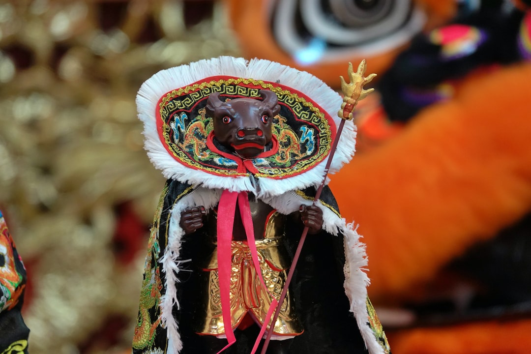 A richly decorated ceremonial mask with intricate patterns and vibrant colors, representing an ancient cultural tradition.
