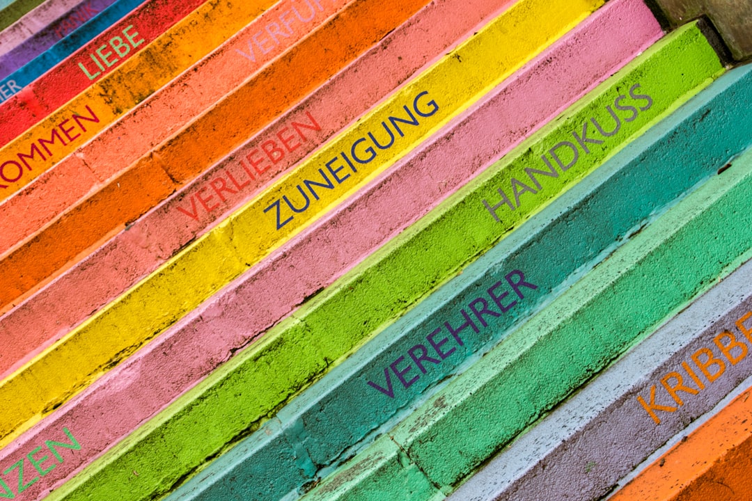 An illustration depicting a spectrum of colors with overlapping cultural symbols and text snippets indicating their varied meanings across different global societies, highlighting cultural diversity in color perception.