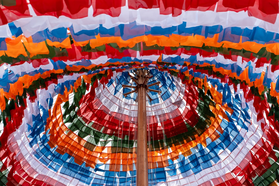 An artistic representation of a world map filled with various color swatches, each associated with different cultural symbols or icons, illustrating the diverse meanings of colors across the globe.