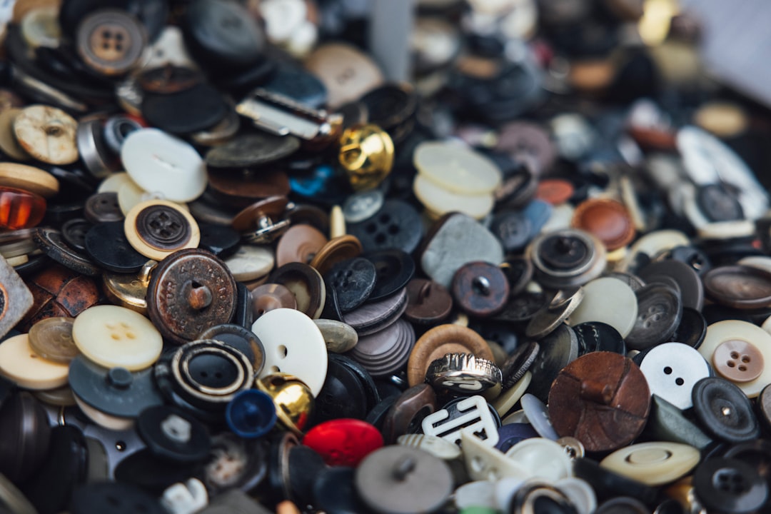 A close-up image of shirt buttons, symbolizing the historical reasons for their different placement on men's and women's clothing based on societal traditions.