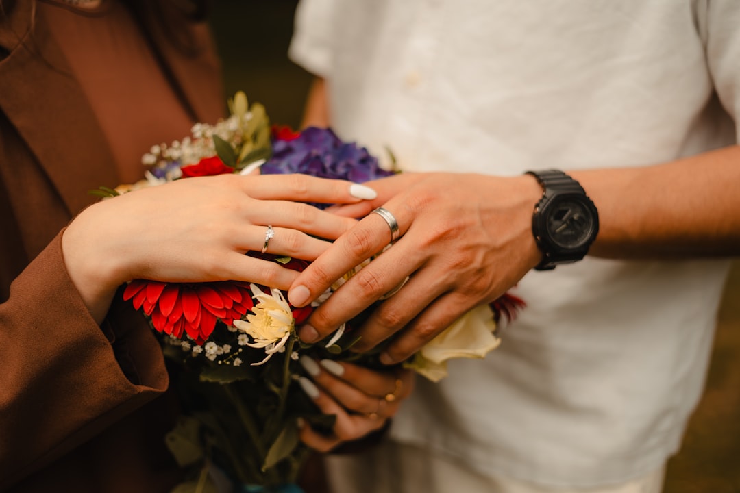 Close-up of a hand with a gold wedding ring on the fourth finger, symbolizing love and ancient traditions surrounding the 'vena amoris'.
