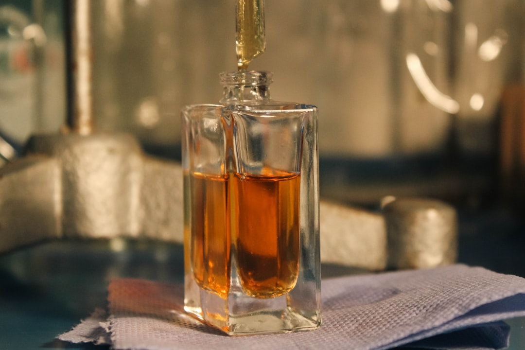 A person applying perfume correctly, focusing on pulse points and avoiding direct facial areas, illustrating the concept of olfactory fatigue.