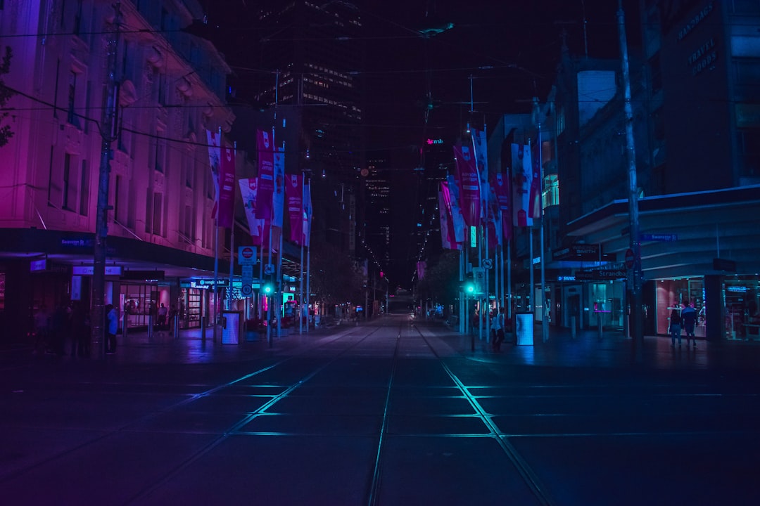 Two people engaged in a deep conversation on a city street at night, symbolizing the real-life encounter that inspired the film Before Sunrise.