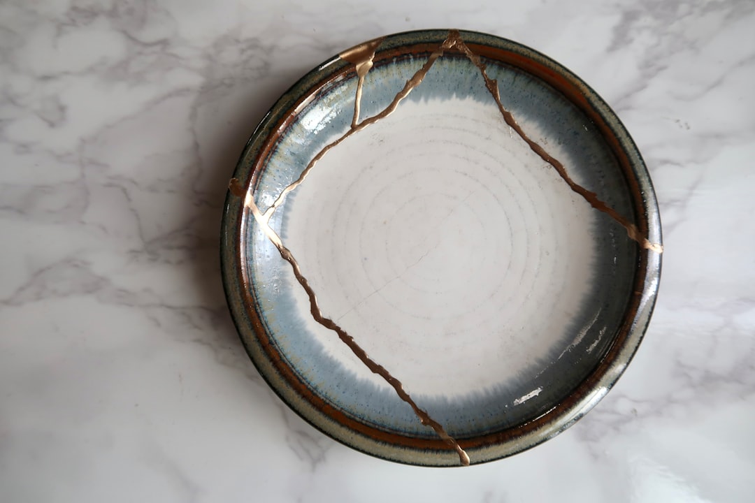 Japanese kintsugi pottery with visible golden repair lines