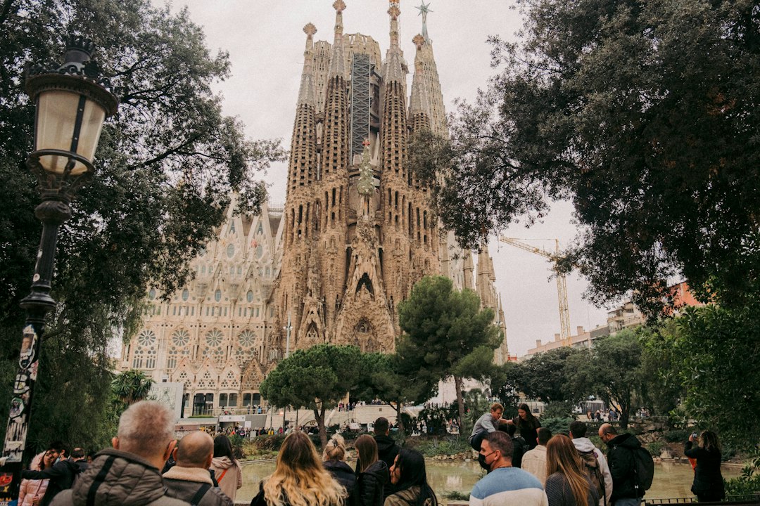 A vibrant table with various Spanish tapas, a glass of wine, and the iconic Sagrada Familia in the background, representing the rich culture of Spain.
