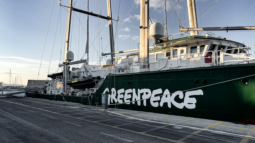 The Greenpeace Rainbow Warrior ship sinking in Auckland harbor after being sabotaged by French secret service agents.