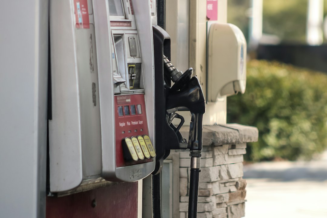 A gas station pump with a vehicle fueling, illustrating the effect of temperature on fuel volume and density.