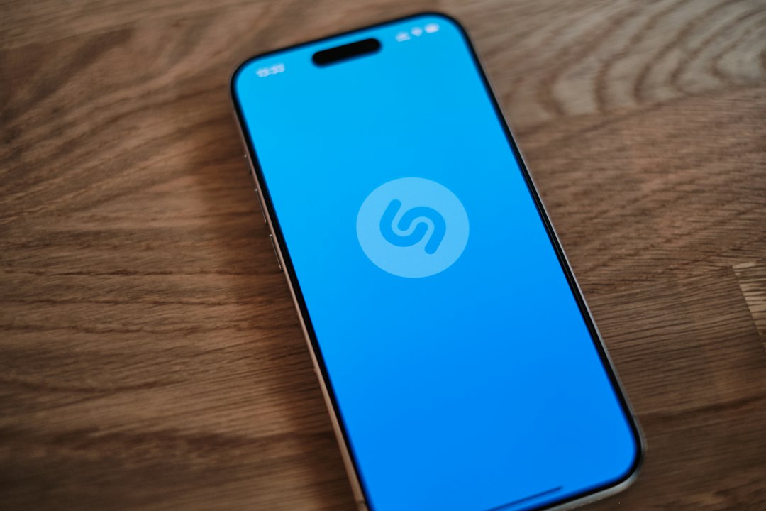 Shazam's acoustic fingerprinting algorithm in action, showing sound waves being processed into a unique digital signature for music recognition.