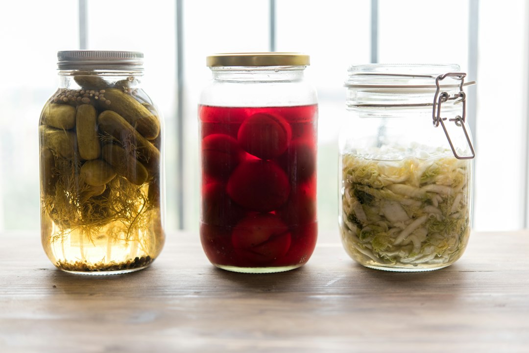 An arrangement of various foods known to support hormone balance, including salmon, avocado, broccoli, oats, and a glass of kefir, symbolizing a healthy diet.